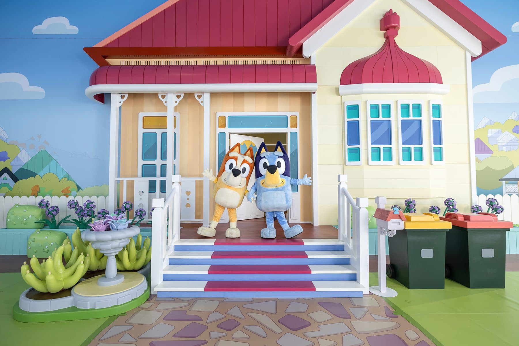 Themed attraction build with a printed scenic backdrop and fabricated house facade